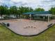 Community playground featuring swings, slides, and covered play areas, perfect for Gathering fun at 16113 Rambling Rd, Odessa, FL 33556