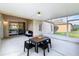 Covered and screened porch with outdoor seating and sliding glass doors to the interior at 16113 Rambling Rd, Odessa, FL 33556