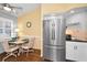 Charming breakfast nook featuring a modern refrigerator and cozy seating arrangement at 1647 Hamilton Ct, Dunedin, FL 34698