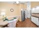 Bright breakfast nook with stylish seating, modern refrigerator, and ample natural light at 1647 Hamilton Ct, Dunedin, FL 34698