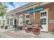 Charming brick building in Dunedin with a vintage cart and bench seating at 1647 Hamilton Ct, Dunedin, FL 34698