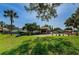A peaceful community area with benches and manicured landscaping at 1647 Hamilton Ct, Dunedin, FL 34698