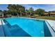 Sparkling community pool with clear blue water surrounded by fencing at 1647 Hamilton Ct, Dunedin, FL 34698