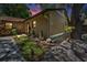 Landscaped area with plants, lighting, rocks and decorative pots adds curb appeal to the front exterior at 1647 Hamilton Ct, Dunedin, FL 34698