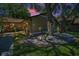 Close-up of the exterior with attractive landscaping featuring mature trees, rocks and decorative pots at 1647 Hamilton Ct, Dunedin, FL 34698