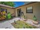 Cozy front porch with landscaping and pavers creates a welcoming entrance at 1647 Hamilton Ct, Dunedin, FL 34698