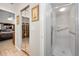 Hallway featuring a walk-in shower and mirrored closet doors at 1647 Hamilton Ct, Dunedin, FL 34698