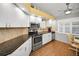 Well-equipped kitchen featuring modern appliances, white cabinets, and stylish backsplash at 1647 Hamilton Ct, Dunedin, FL 34698