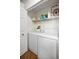 Bright laundry room featuring a washer and dryer unit at 1647 Hamilton Ct, Dunedin, FL 34698