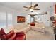 Bright living room with plush seating, ceiling fan, and artwork creating a welcoming space at 1647 Hamilton Ct, Dunedin, FL 34698