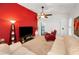 Comfortable living room features white sofas, soft carpet, and a colorful accent wall at 1647 Hamilton Ct, Dunedin, FL 34698