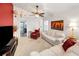 Bright living room with plush carpeting, neutral furniture, and a sliding glass door to the backyard at 1647 Hamilton Ct, Dunedin, FL 34698