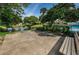 A tranquil community pond with fountain, landscaping, and lush greenery near the pool at 1647 Hamilton Ct, Dunedin, FL 34698