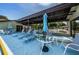 Serene community poolside lounge area with ample seating and sun loungers at 1647 Hamilton Ct, Dunedin, FL 34698