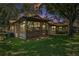 Inviting home exterior featuring a glassed-in porch and lush green lawn at 1647 Hamilton Ct, Dunedin, FL 34698