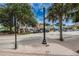 A lively street with a variety of shops, mature trees, and a sidewalk, perfect for exploring the local area at 1647 Hamilton Ct, Dunedin, FL 34698