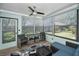 Relaxing sunroom with lots of natural lighting and comfortable wicker furniture at 1647 Hamilton Ct, Dunedin, FL 34698