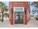 The Greater Dunedin Chamber of Commerce and Visitor Center welcomes guests with a classic brick building and inviting entrance at 1647 Hamilton Ct, Dunedin, FL 34698
