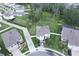 Bright two-story home features solar panels, a two-car garage, driveway parking, and a spacious lawn backing to a wooded area at 16633 Goose Ribbon Pl, Wimauma, FL 33598