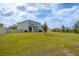 Large backyard, home with screened lanai, and a privacy fence at 16633 Goose Ribbon Pl, Wimauma, FL 33598