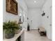 Welcoming entryway with neutral tile flooring, white walls and decorative accents at 16633 Goose Ribbon Pl, Wimauma, FL 33598