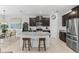 Kitchen with granite countertops, stainless steel appliances, and seating at the island at 16633 Goose Ribbon Pl, Wimauma, FL 33598