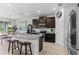 Kitchen with granite countertops, stainless steel appliances, and seating at the island at 16633 Goose Ribbon Pl, Wimauma, FL 33598