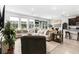 Bright living room with neutral colored furniture, tiled floors, and an open floor plan at 16633 Goose Ribbon Pl, Wimauma, FL 33598