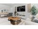 Comfortable living room with a decorative wood coffee table and natural lighting at 16633 Goose Ribbon Pl, Wimauma, FL 33598