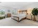 Inviting main bedroom boasts natural light, comfortable furniture, and neutral tones for a serene ambiance at 16633 Goose Ribbon Pl, Wimauma, FL 33598
