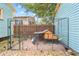 Backyard of a turquoise home featuring a chicken coop within a large outdoor cage area at 1708 E 15Th Ave, Tampa, FL 33605