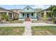 Charming blue home with inviting front porch and steps to the front door at 1708 E 15Th Ave, Tampa, FL 33605