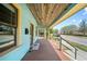 Spacious front porch with a wooden ceiling, offering a relaxing outdoor space at 1708 E 15Th Ave, Tampa, FL 33605