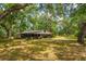 The property includes a large barn surrounded by mature trees and a grassy field at 19266 Campground Rd, Brooksville, FL 34601