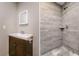 Bathroom showcasing a modern vanity with wood-look tile in the shower and stylish hexagon tile on the floor at 19266 Campground Rd, Brooksville, FL 34601