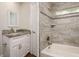 This bathroom offers a white vanity and framed mirror, a tile shower and updated fixtures at 19266 Campground Rd, Brooksville, FL 34601