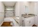 This bathroom offers a white vanity and framed mirror, a tile shower and updated fixtures at 19266 Campground Rd, Brooksville, FL 34601
