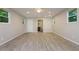 Spacious bedroom features wood-look tile flooring, a ceiling fan, recessed lighting, and access to the bathroom at 19266 Campground Rd, Brooksville, FL 34601