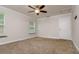 Well-lit bedroom with ceiling fan, closet, and a large window at 19266 Campground Rd, Brooksville, FL 34601