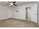 Comfortable bedroom with neutral carpet and ensuite bathroom with a glass shower at 19266 Campground Rd, Brooksville, FL 34601