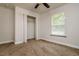 Bright bedroom with carpet, closet, and a large window at 19266 Campground Rd, Brooksville, FL 34601