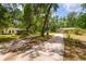 Long driveway leading to a single Gathering home and outbuilding at 19266 Campground Rd, Brooksville, FL 34601