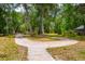 Circular driveway providing ample parking space and easy access to the property through the lush, green landscape at 19266 Campground Rd, Brooksville, FL 34601