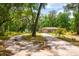 The home is situated on a large lot with mature trees and a circular driveway at 19266 Campground Rd, Brooksville, FL 34601