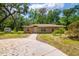Charming single-story home features a concrete driveway and well-maintained landscaping at 19266 Campground Rd, Brooksville, FL 34601