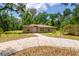 Charming single-story home features a concrete driveway and well-maintained landscaping at 19266 Campground Rd, Brooksville, FL 34601