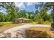 Charming single-story home with a circular driveway and lush landscaping at 19266 Campground Rd, Brooksville, FL 34601
