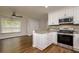 Bright kitchen features stainless steel appliances, granite counters and white cabinets at 19266 Campground Rd, Brooksville, FL 34601