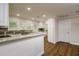 Spacious kitchen with granite countertops, stainless steel appliances, and white cabinets at 19266 Campground Rd, Brooksville, FL 34601