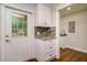 Laundry Room showing a washer and dryer, white cabinets, and granite countertop at 19266 Campground Rd, Brooksville, FL 34601